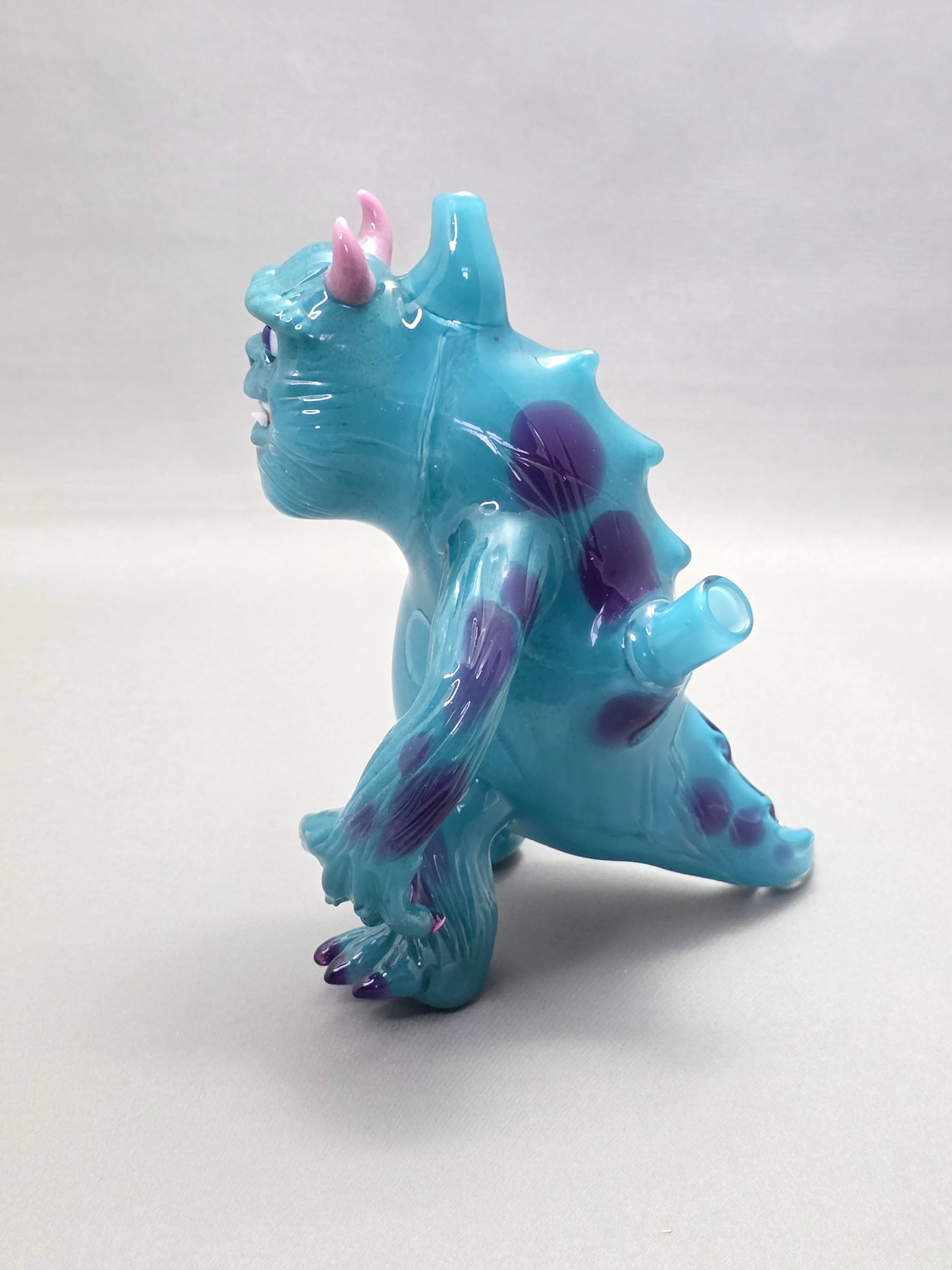 Robertson Glass Rig Blue monster figurine with purple spots on a white background