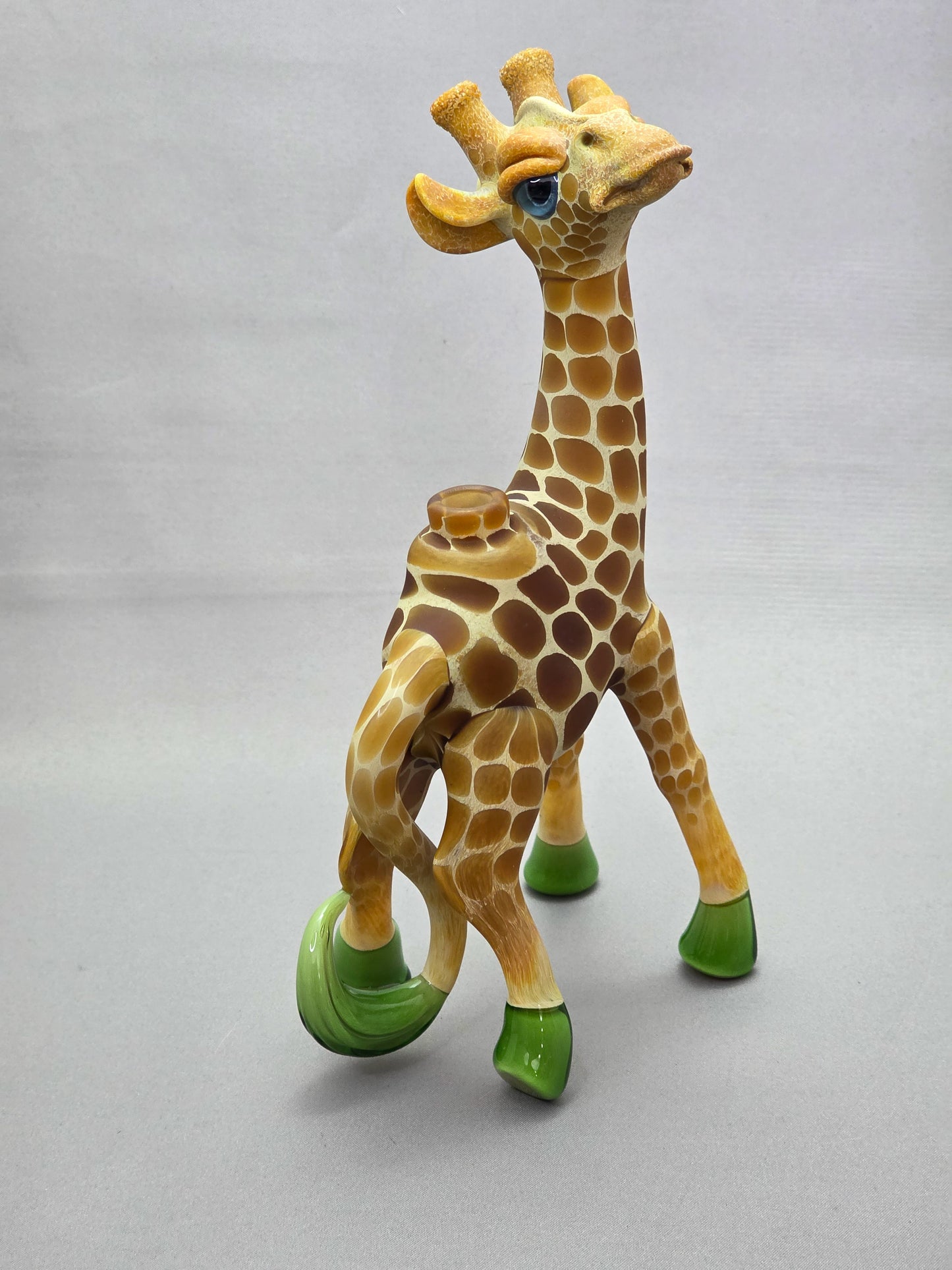 Robertson Glass Giraffe-shaped glass pipe on a light grey background