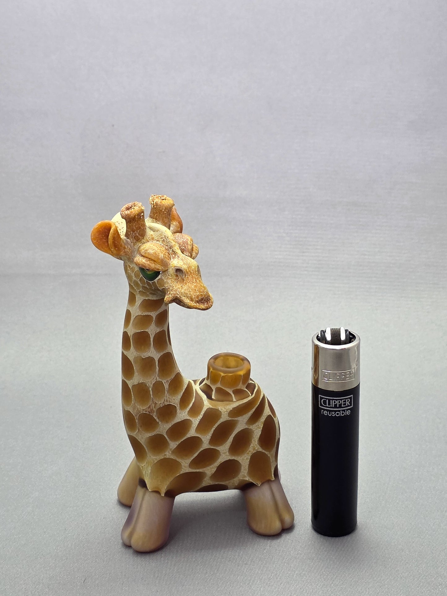 Robertson Glass Giraffe-shaped glass pipe on a light grey background