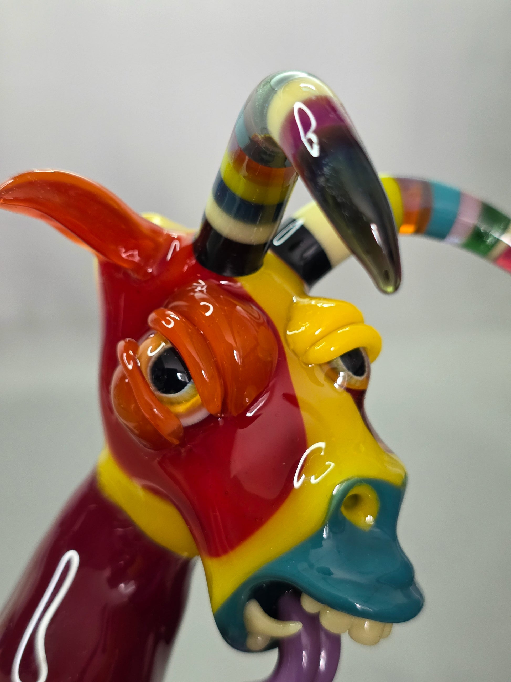 Robertson Glass Colourful glass Goat sculpture on a grey background