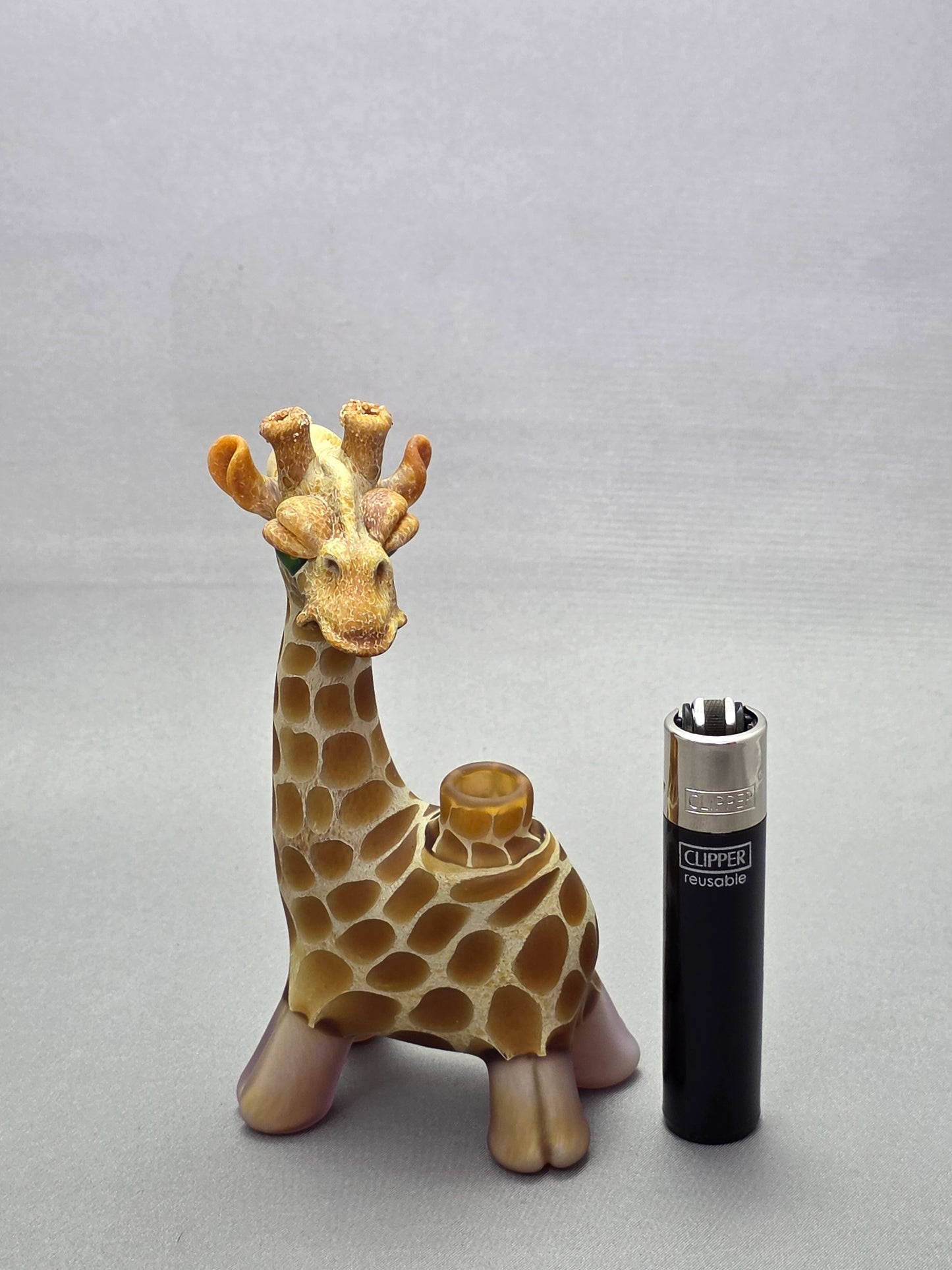 Robertson Glass Giraffe-shaped glass pipe on a light grey background