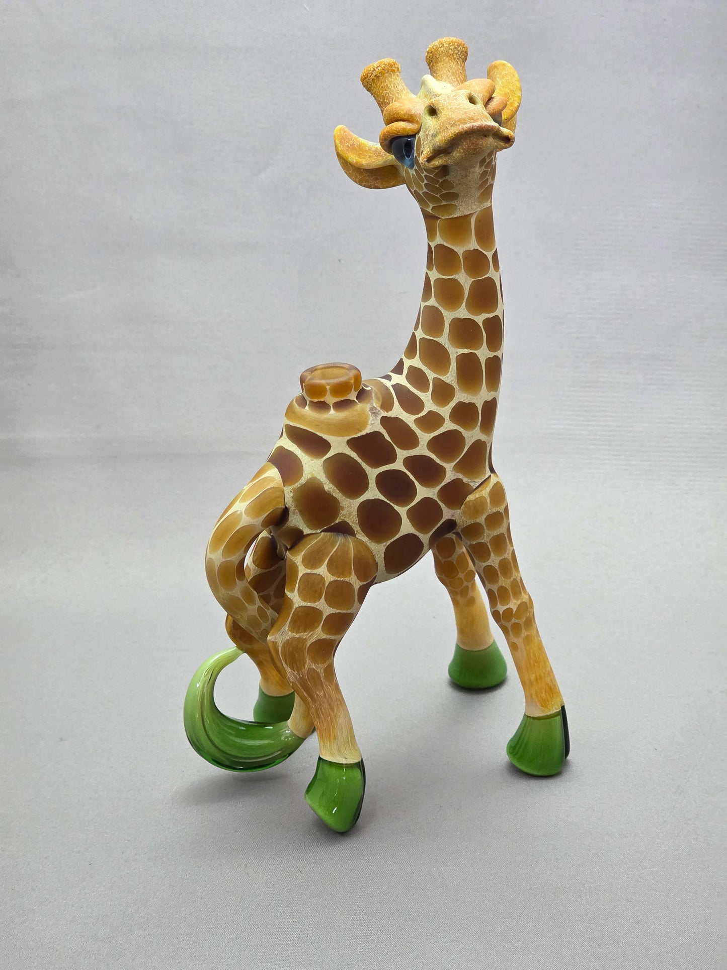 Robertson Glass Giraffe-shaped glass pipe on a light grey background