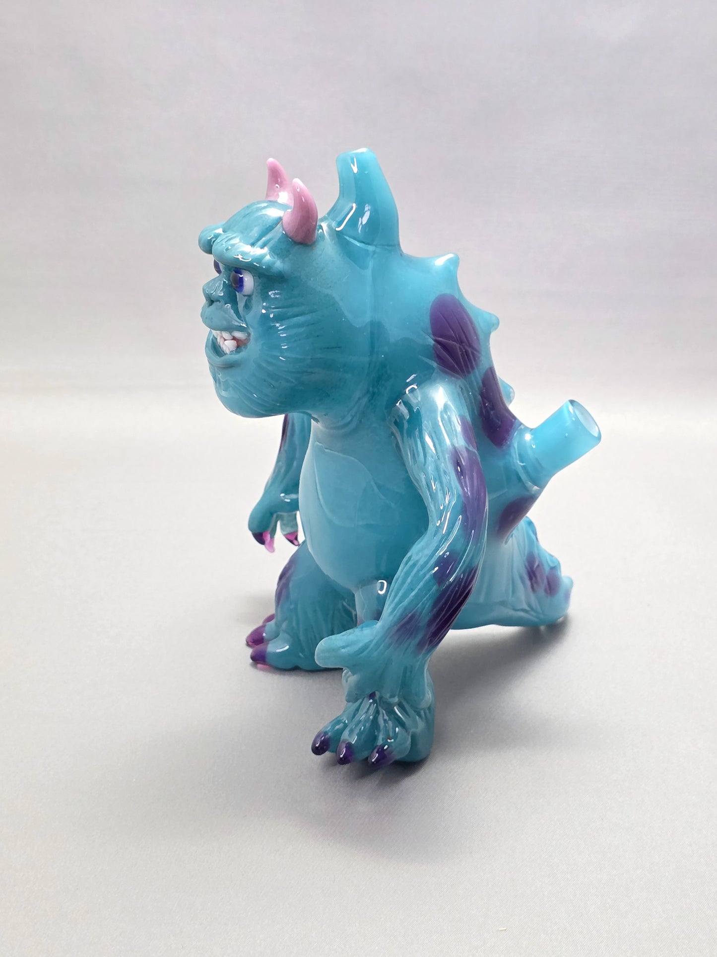 Robertson Glass Rig Blue monster figurine with purple spots on a white background