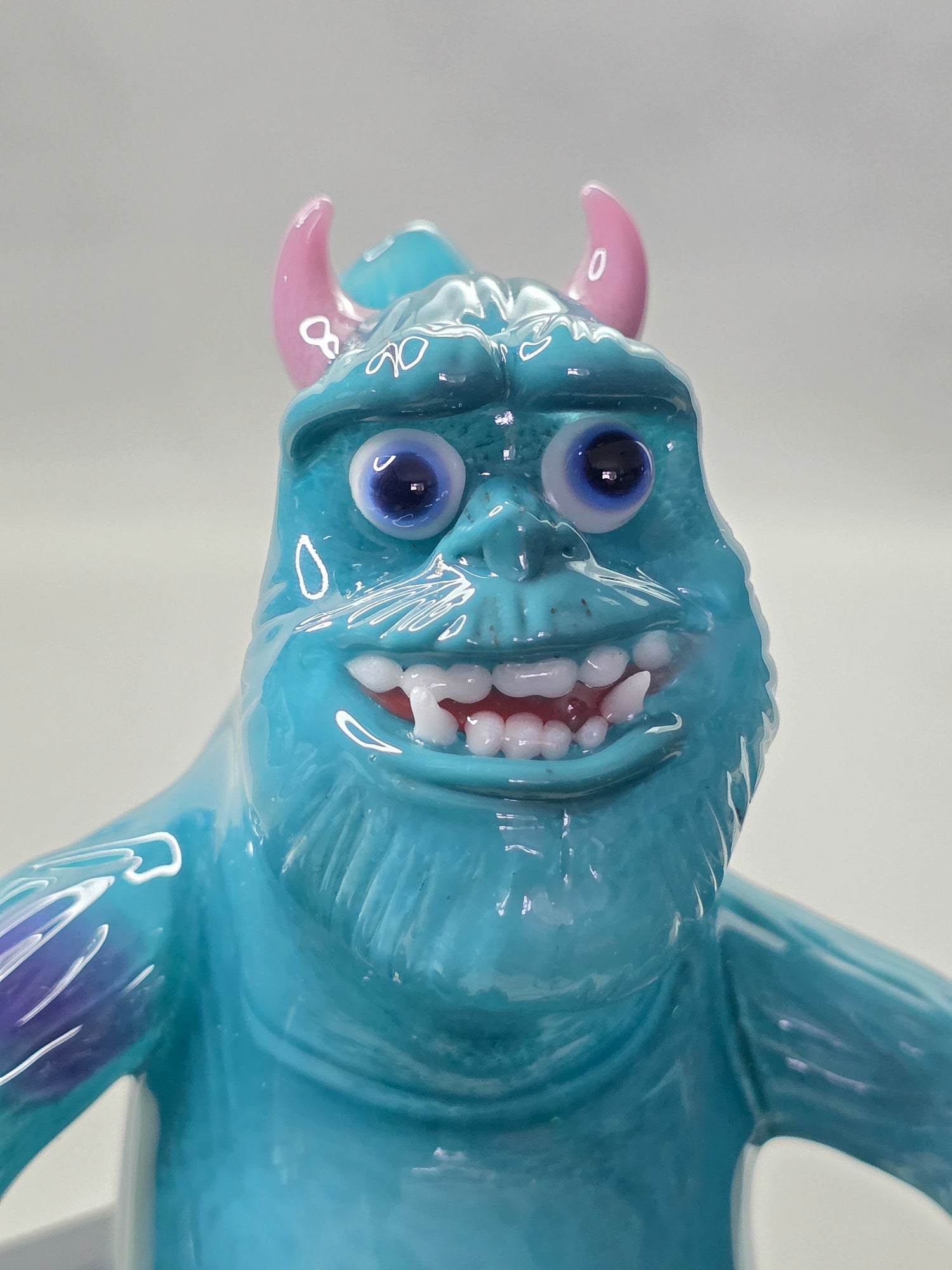 Robertson Glass Rig Blue monster figurine with purple spots on a white background