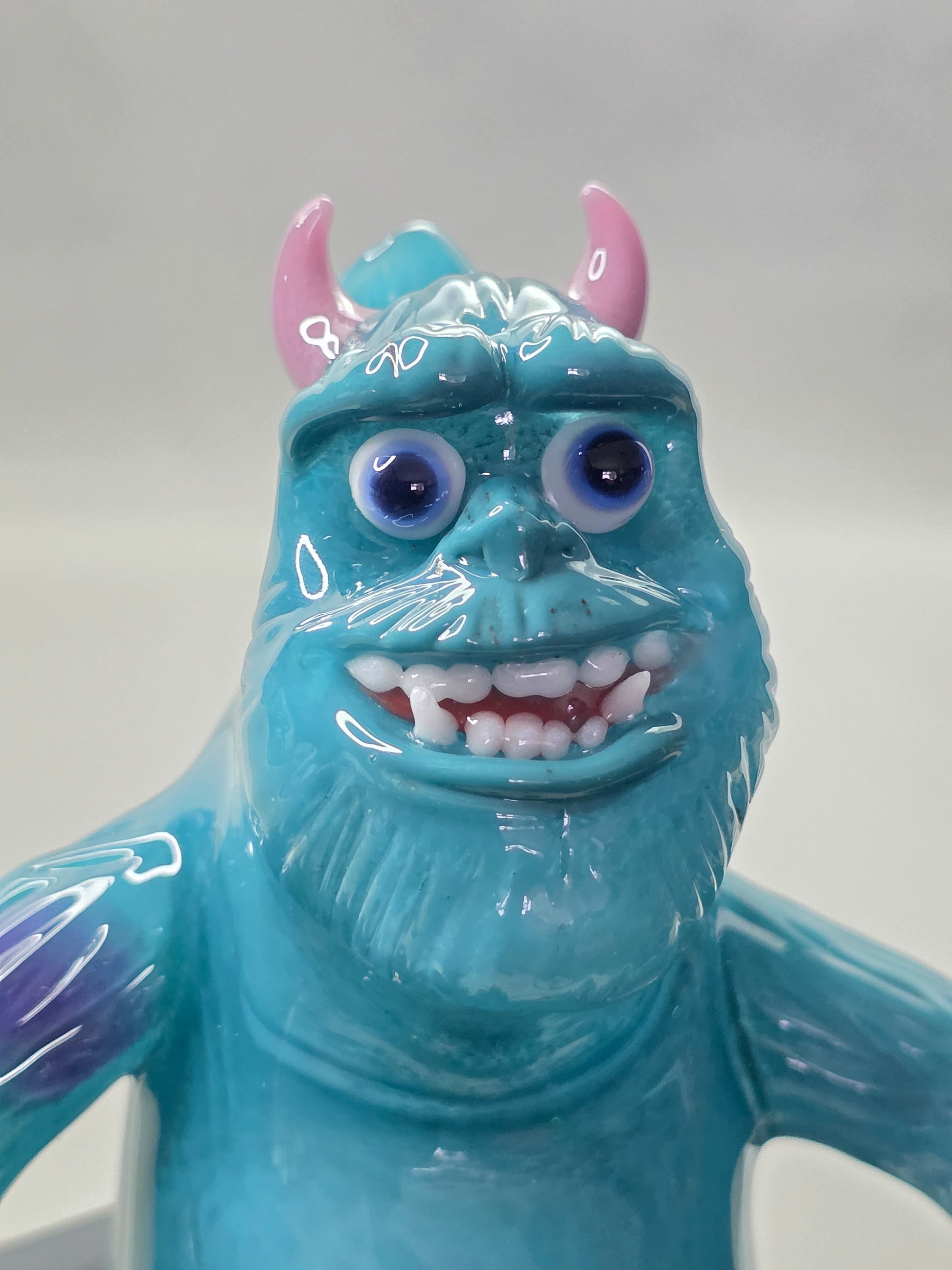 Robertson Glass Rig Blue monster figurine with purple spots on a white background
