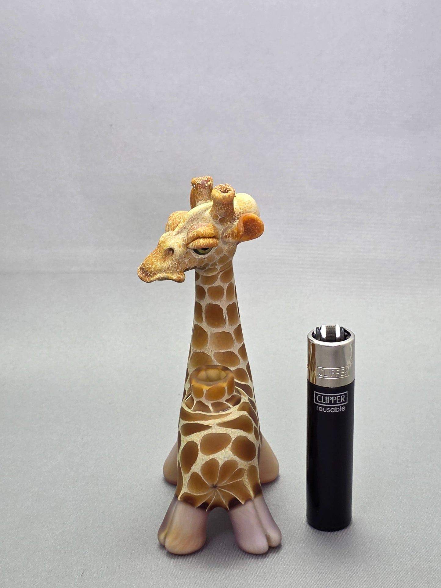 Robertson Glass Giraffe-shaped glass pipe on a light grey background