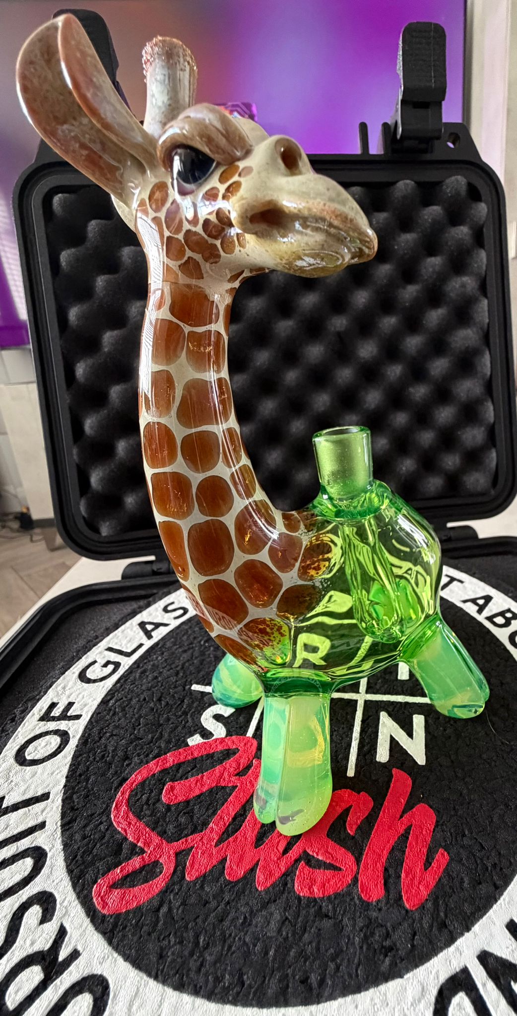 Robertson Glass Glass giraffe rig on a black mood mat surface with text