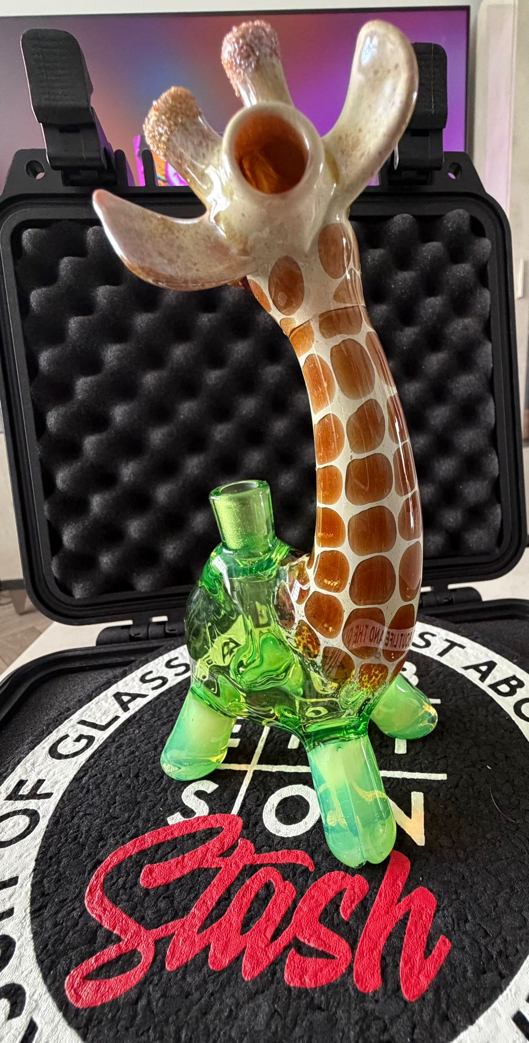 Robertson Glass Glass giraffe rig on a black mood mat surface with text