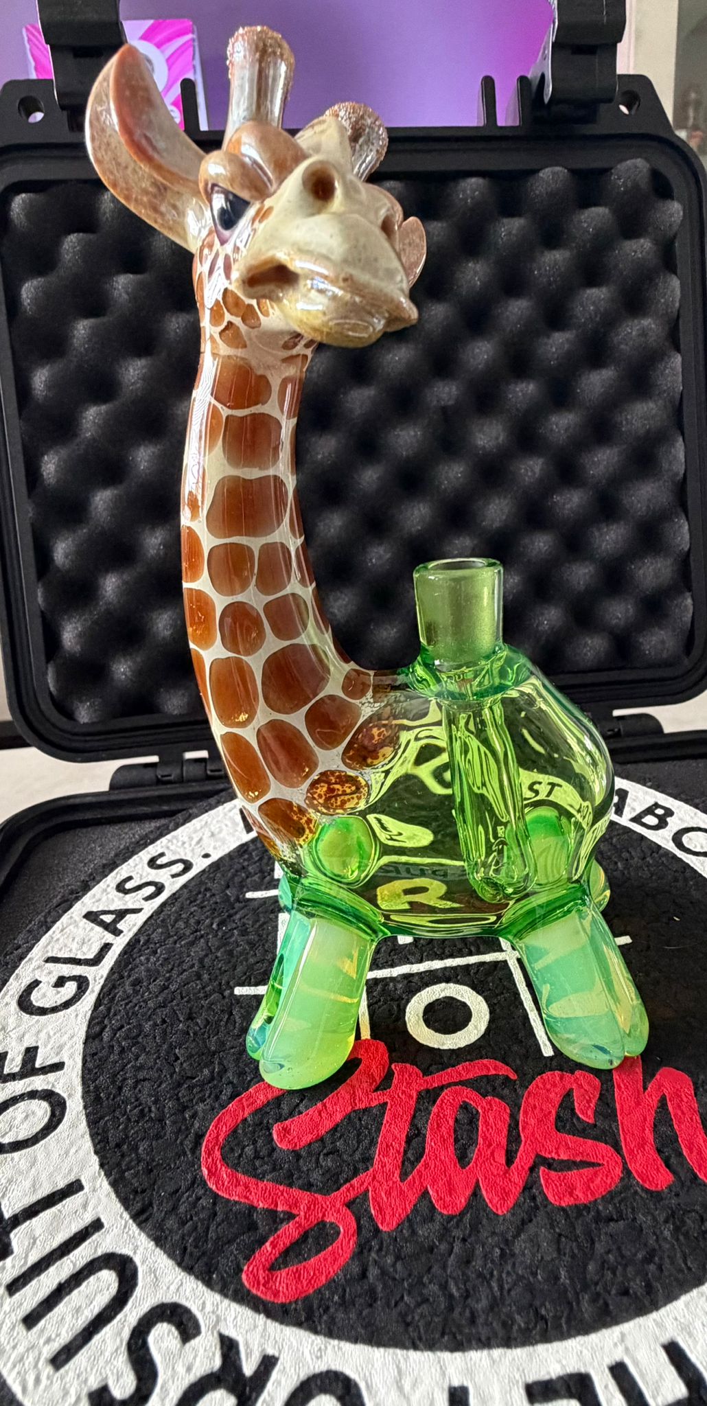 Robertson Glass Glass giraffe rig on a black mood mat surface with text