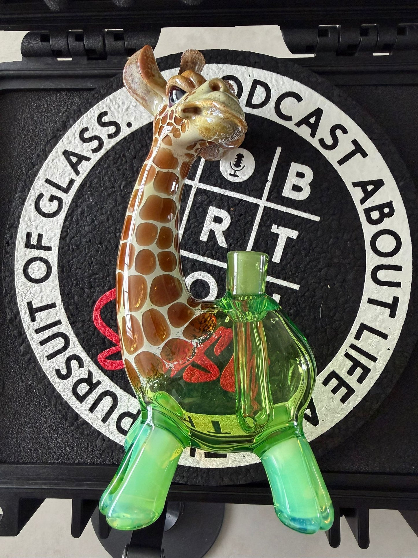 Robertson Glass Glass giraffe rig on a black mood mat surface with text