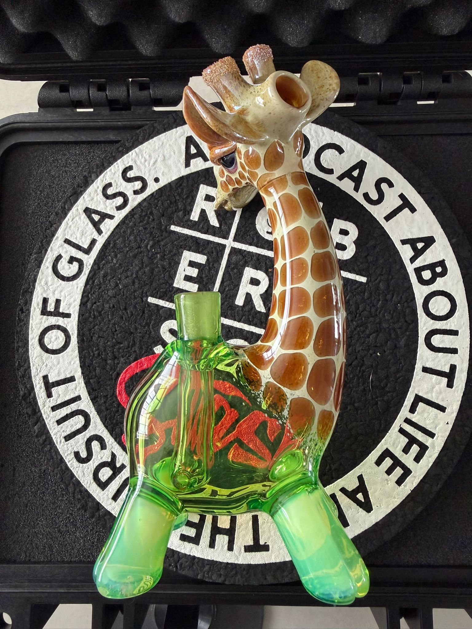 Robertson Glass Glass giraffe rig on a black mood mat surface with text