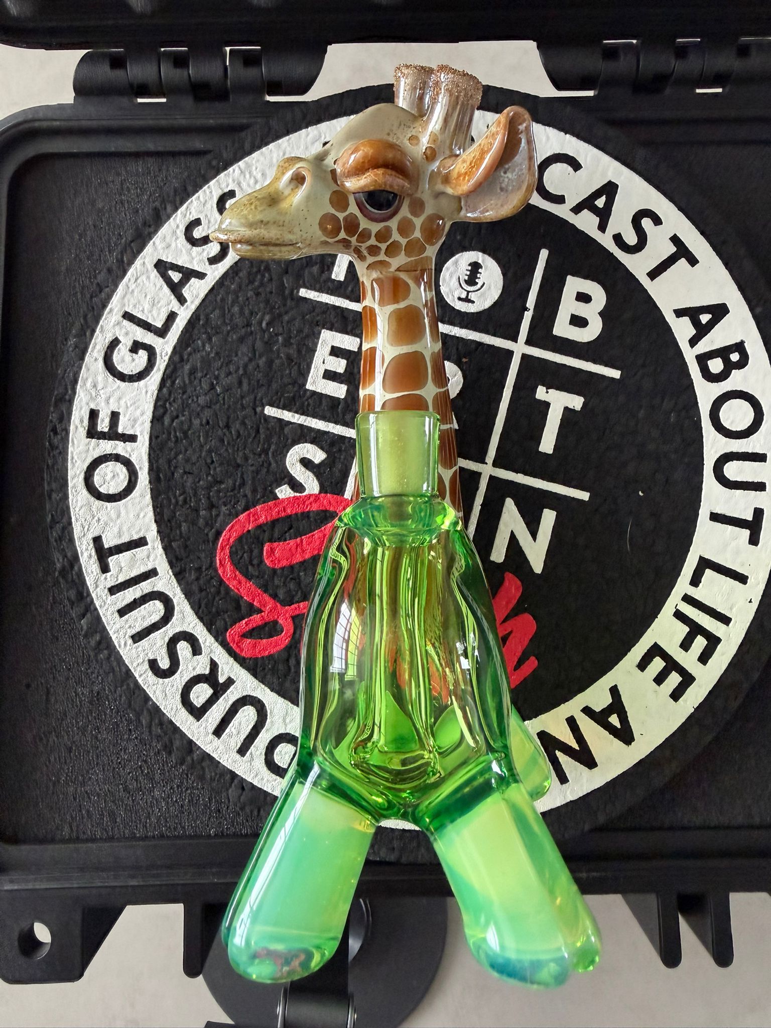 Robertson Glass Glass giraffe rig on a black mood mat surface with text