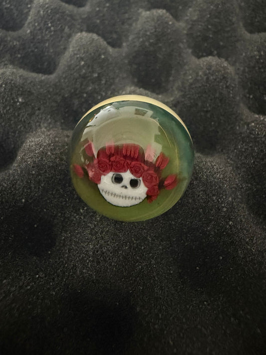 Glass Marble with a character design on a textured black background