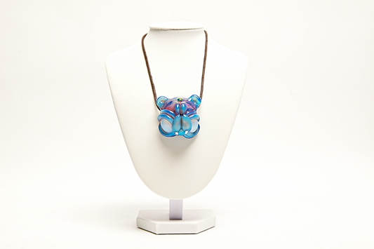 Pendant necklace on a white stand with a white background