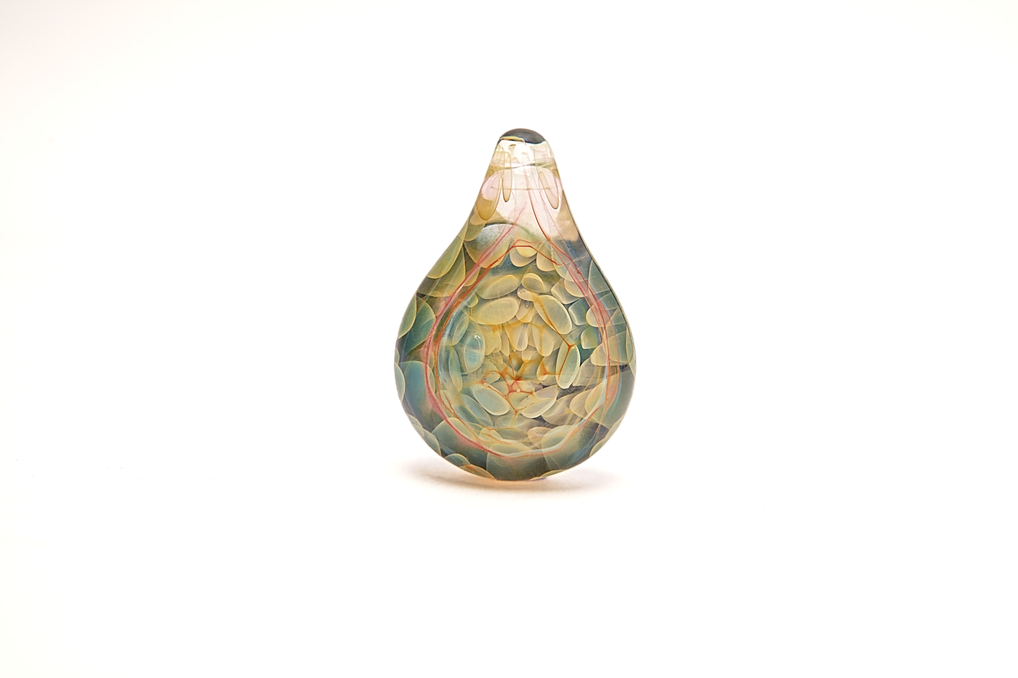 Decorative glass teardrop ornament with intricate patterns on a white background