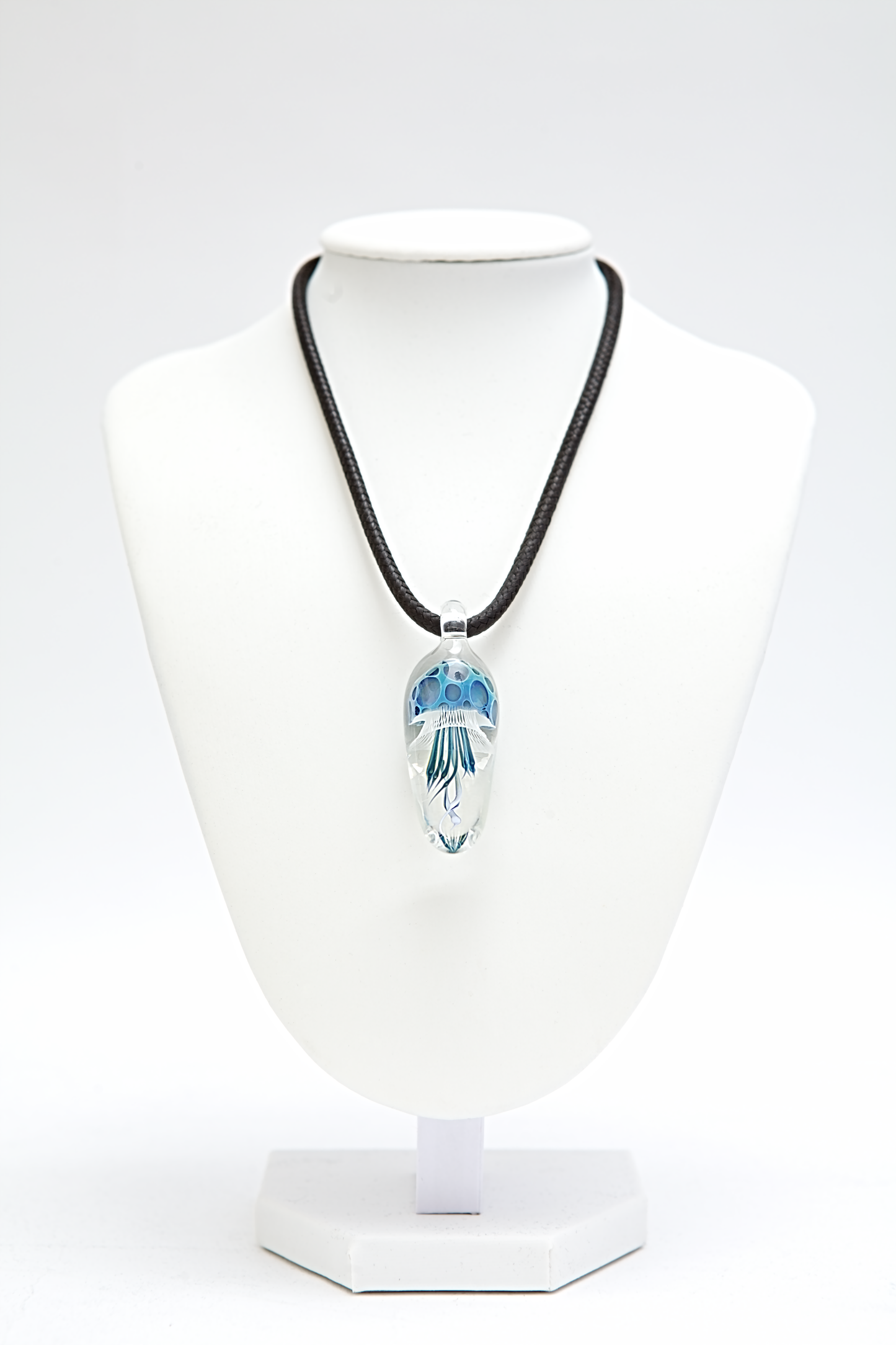 Necklace with a pendant on a white mannequin bust against a white background