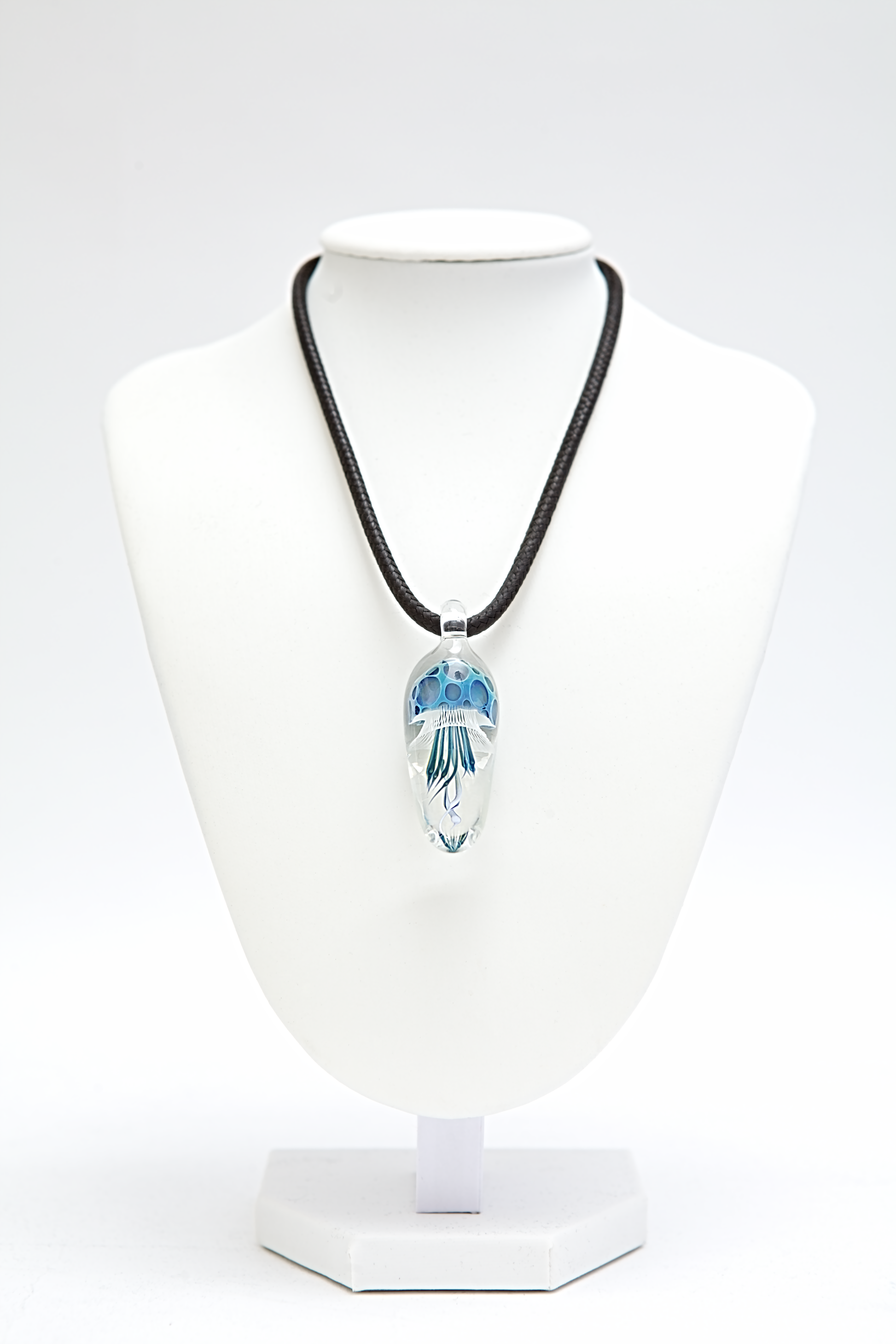 Necklace with a pendant on a white mannequin bust against a white background