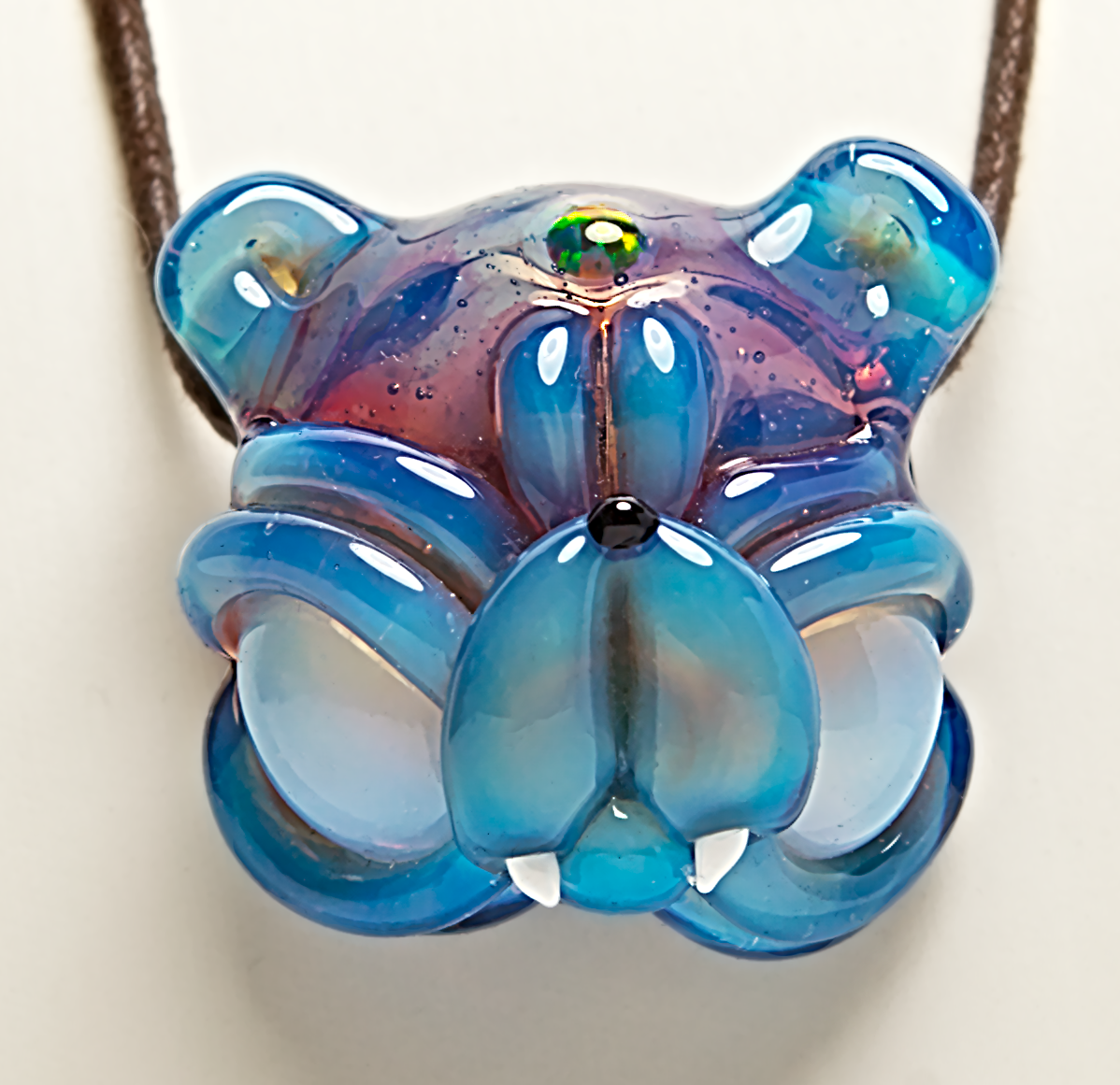 Blue glass pendant on a white background