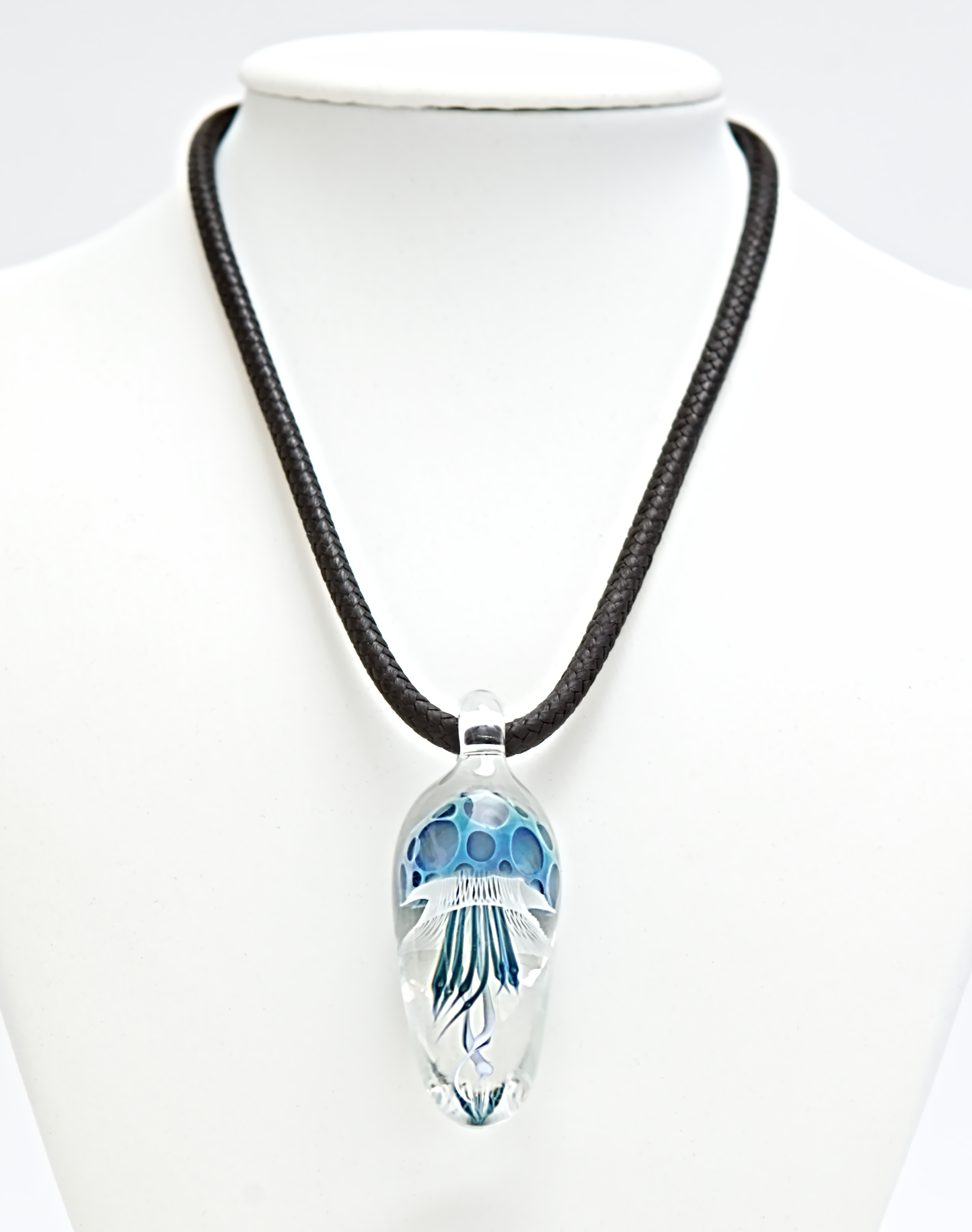 Necklace with a clear pendant featuring blue accents on a white background