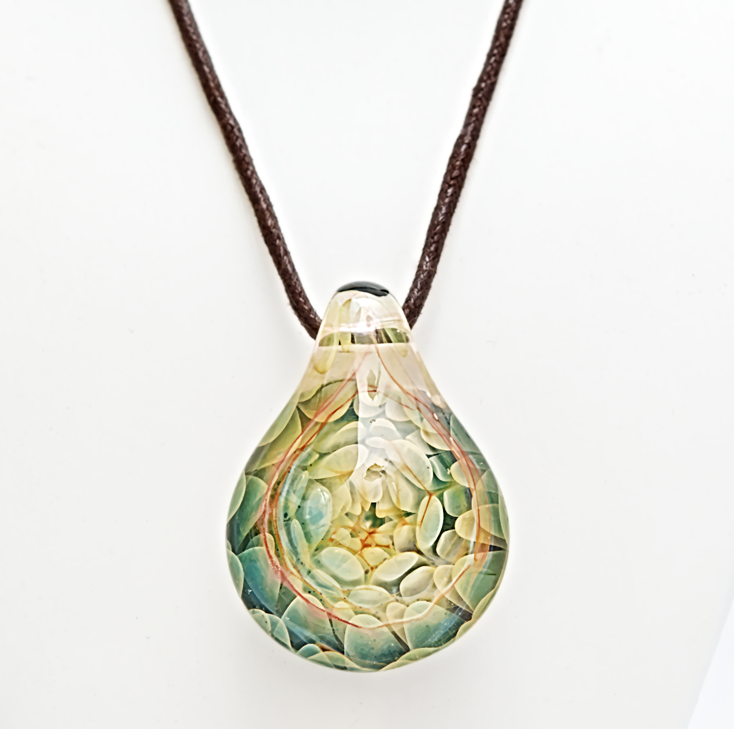 Teardrop-shaped pendant with a textured surface on a white background