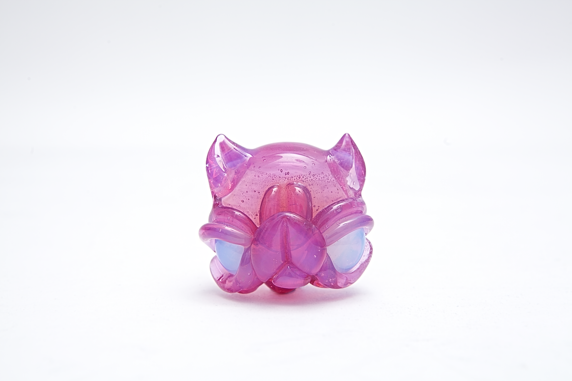 Pink and purple toy figure pendant on a white background