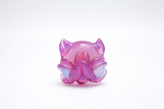 Pink and purple toy figure pendant on a white background