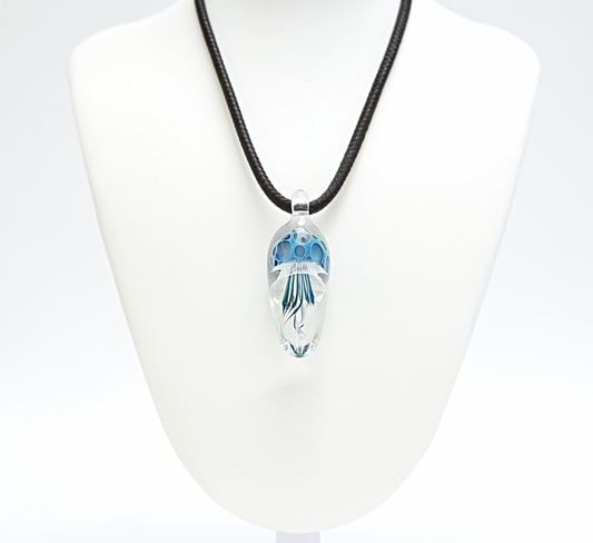 Necklace with a clear pendant featuring blue floral design on a white background