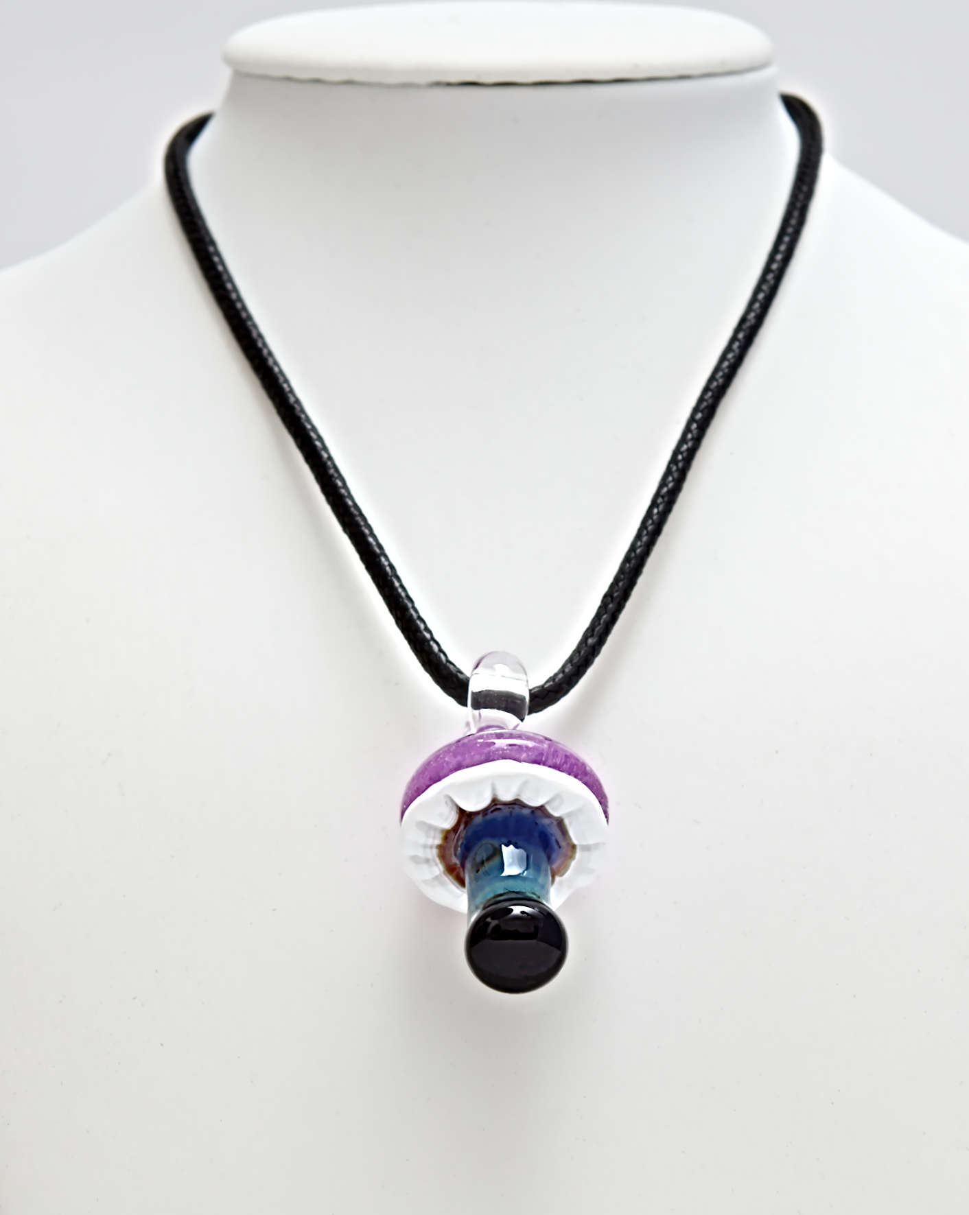 Necklace with a multicolored pendant on a mannequin against a white background